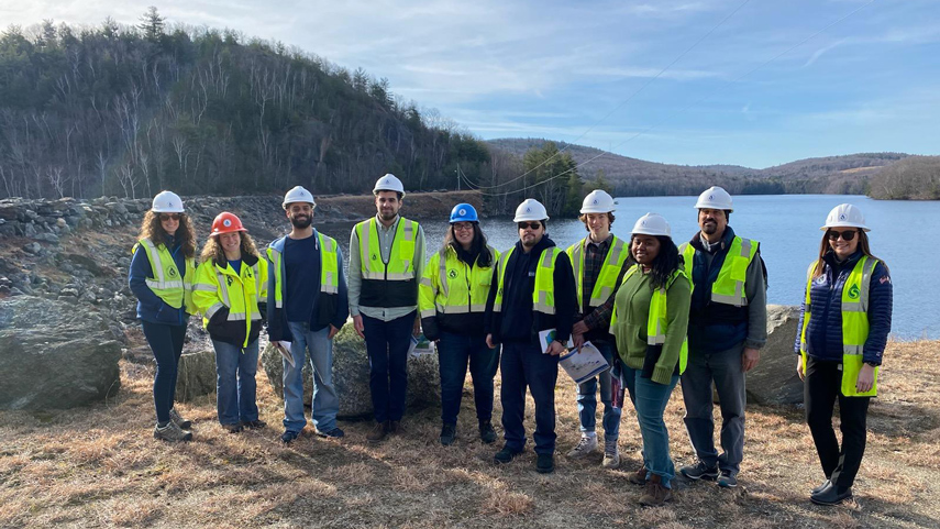 students in reflective vests and hard hats at drinking water reservoir