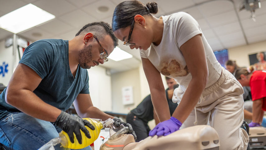 EMT students learning CPR on simulation patient