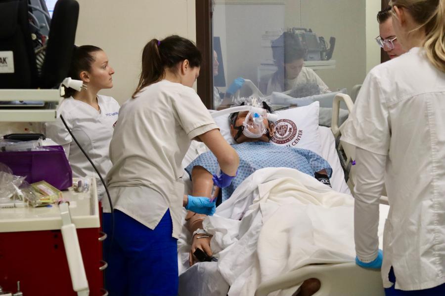 STCC nursing students work on simulator