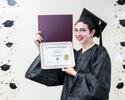 HiSET Graduate holding diploma