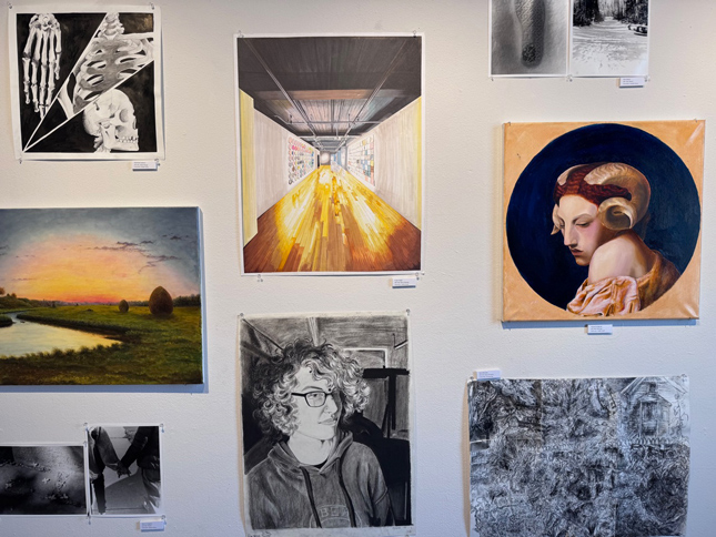 a selection of student art on the gallery wall