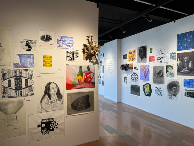 back corner of showcase with cool art sticking out of the wall