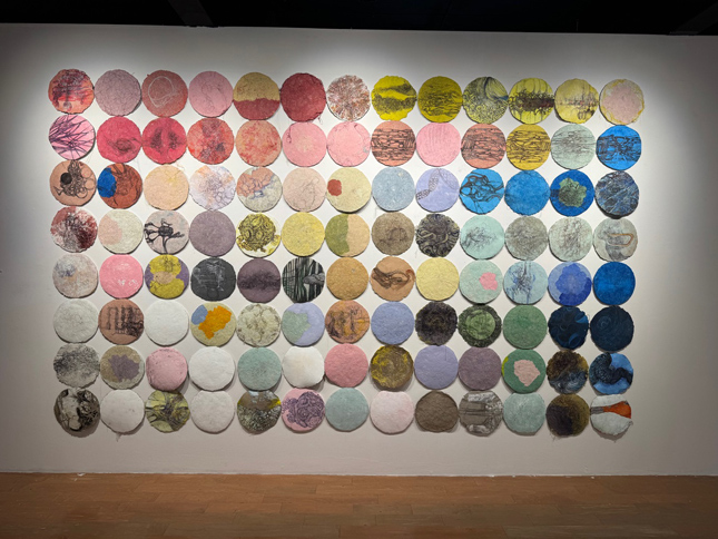 wall of colored and textured circles. It feels like a giant game of twister directed by David Cronenberg