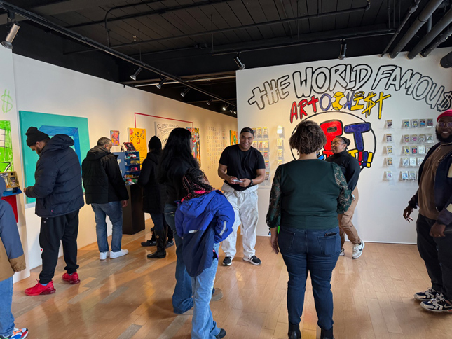 people interacting with the exhibition at the reception