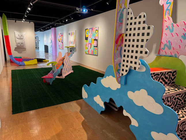 children's playground equipment painted with gleeful contrasting colors such as black and white leopard print, polka dots, and cloudy skies