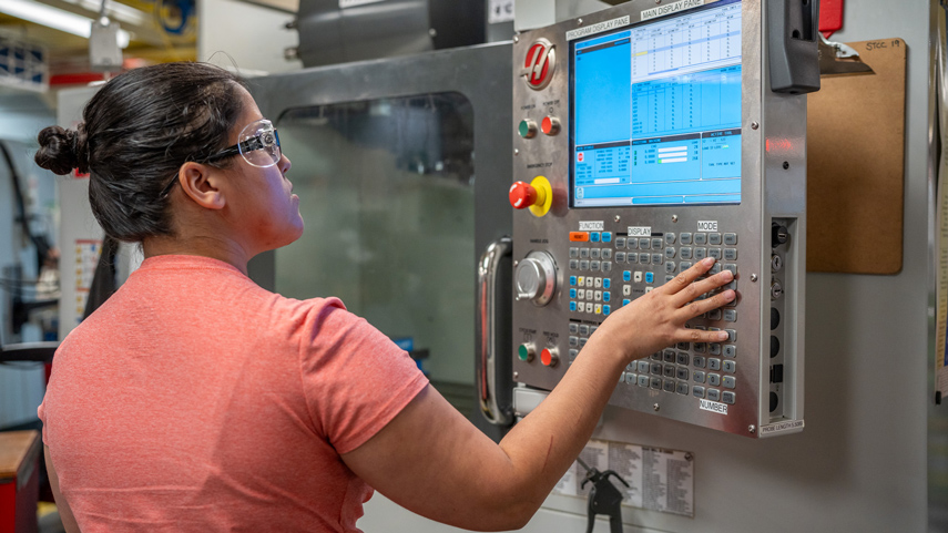 student working at CNC machine