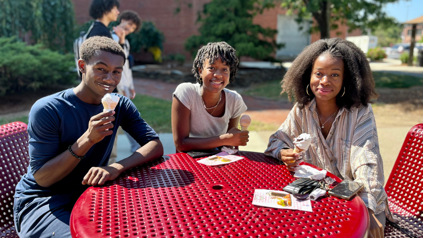 students eating ice cream at picnic table