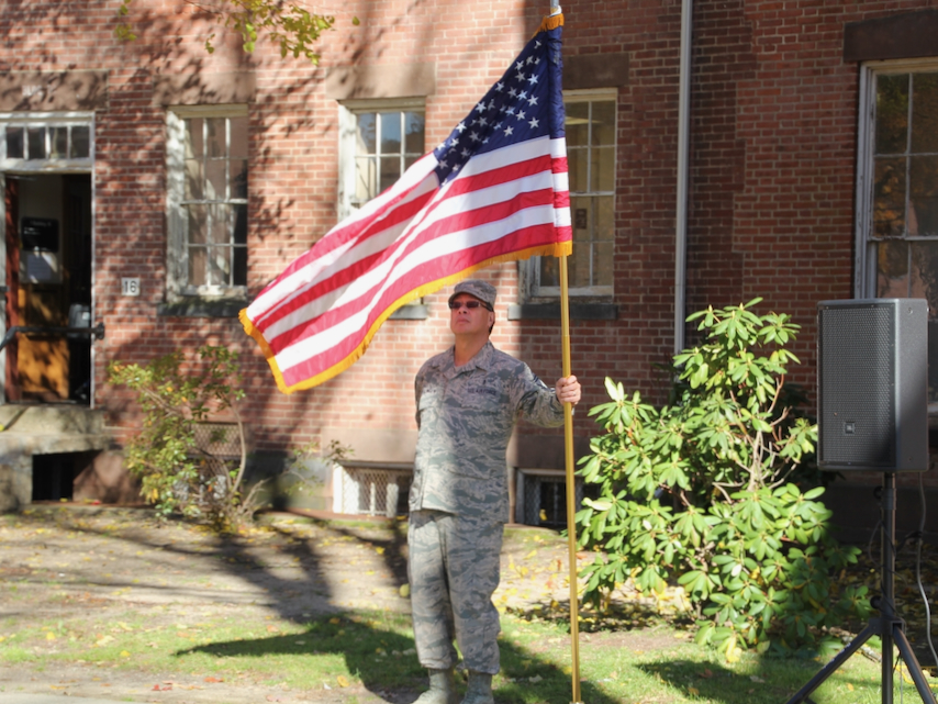 Military veteran holds flag at STCC